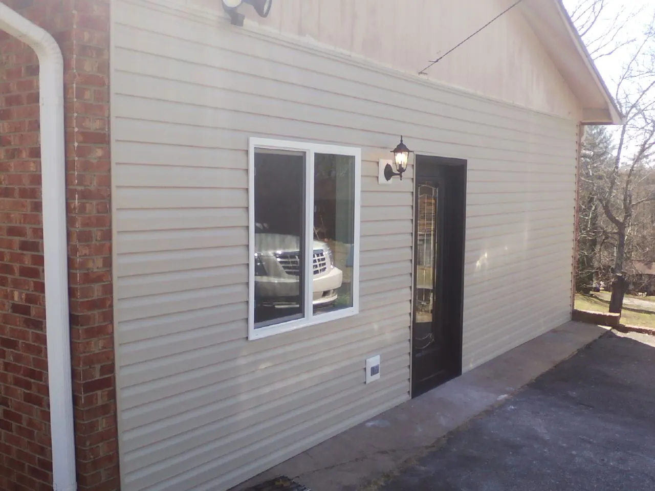New vinyl siding and entry door on a room addition in Burbank